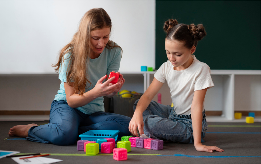 educator and child playing with blocks