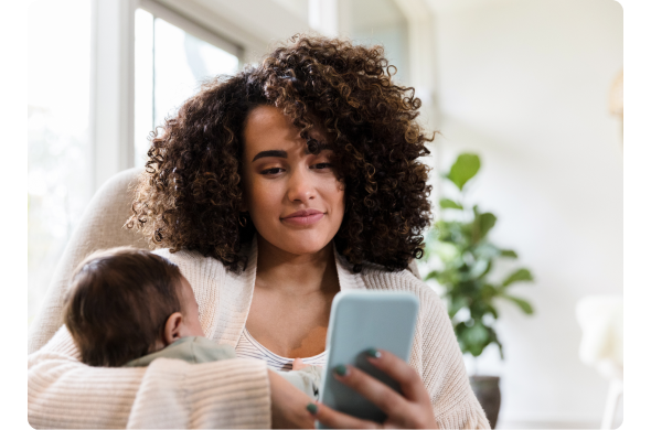 Woman with infant looking at phone