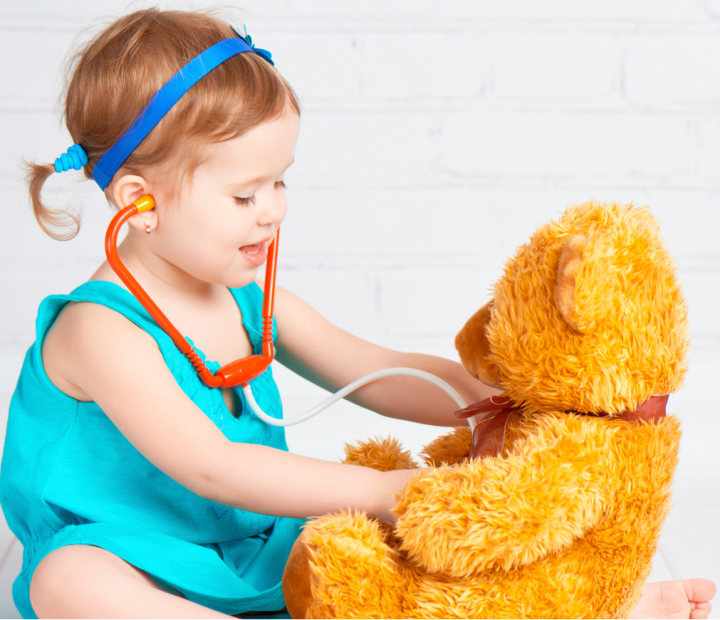 A picture of a young girl playing doctor with her teddy bear, to introduce Quality Area 2 Health & Safety