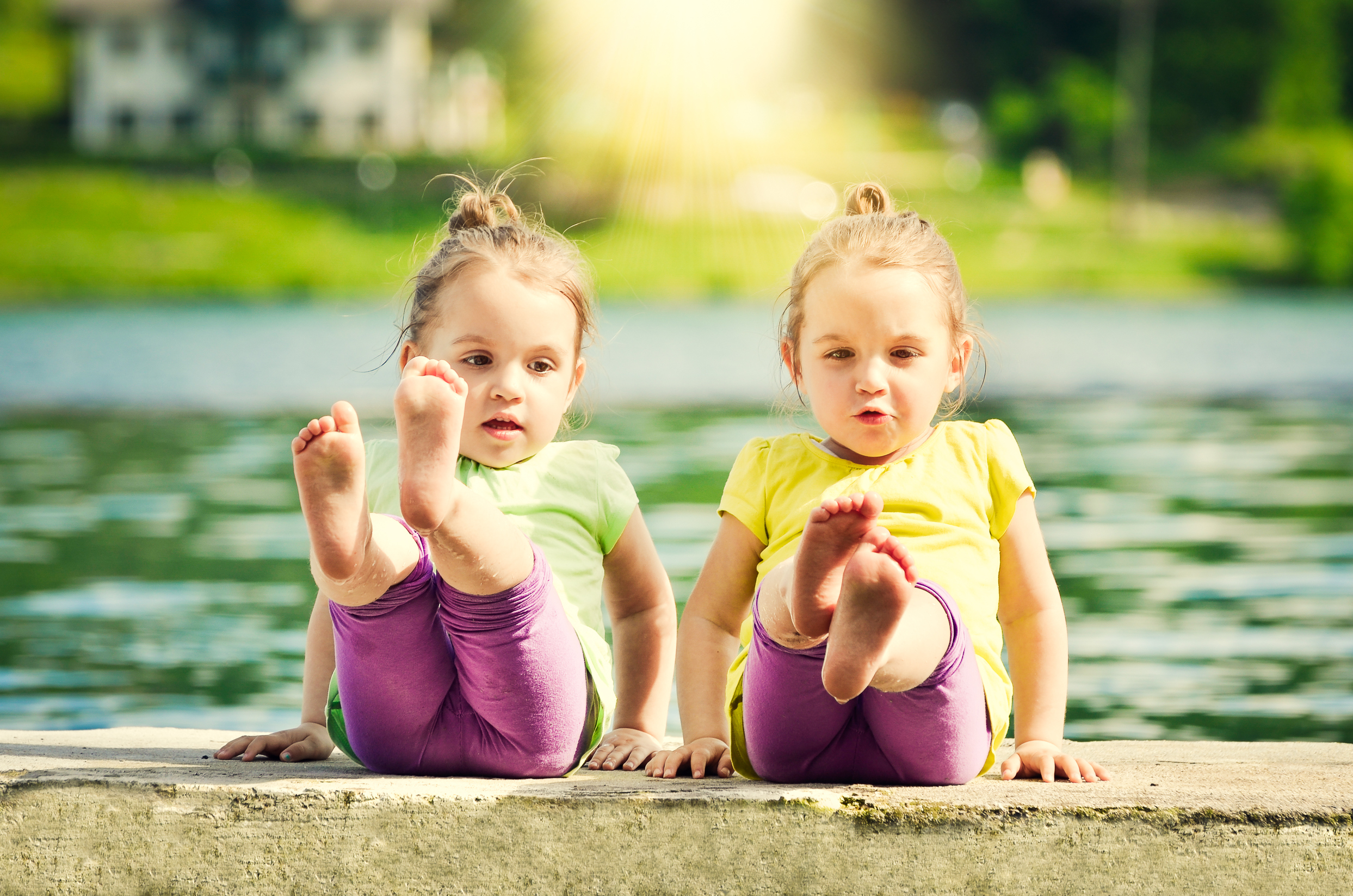 Twin girls in matching outfits holding a pose outdoor