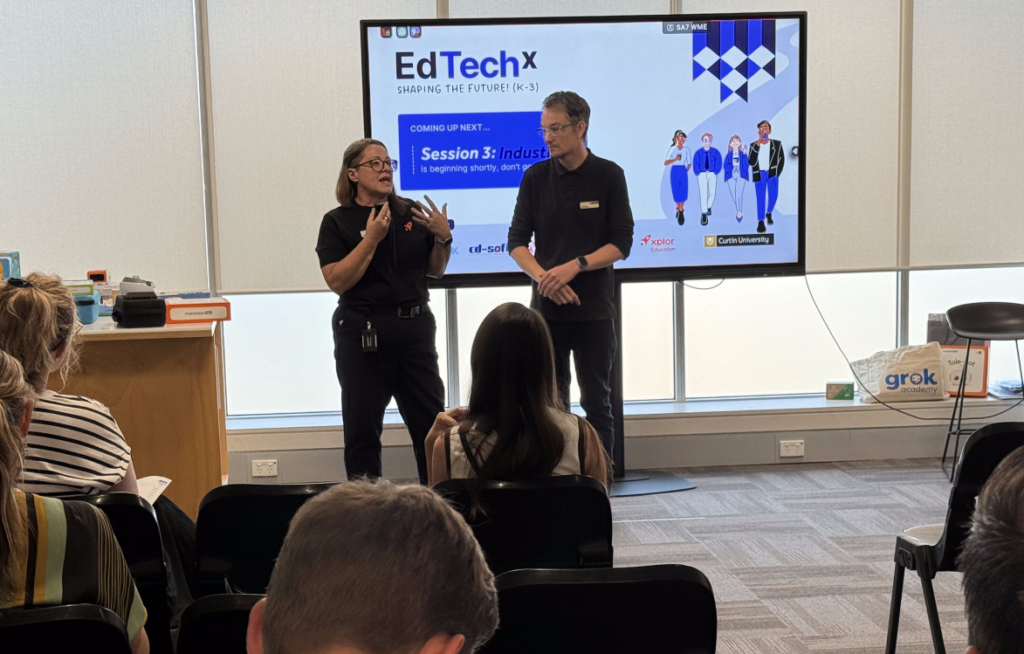 Male and female presenters from Curtin University present in front of screen with an EdTechX slide for Session 3.