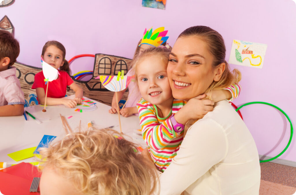 A young child hugging an educator, representing how intimate care is an ECEC service occupancy driver
