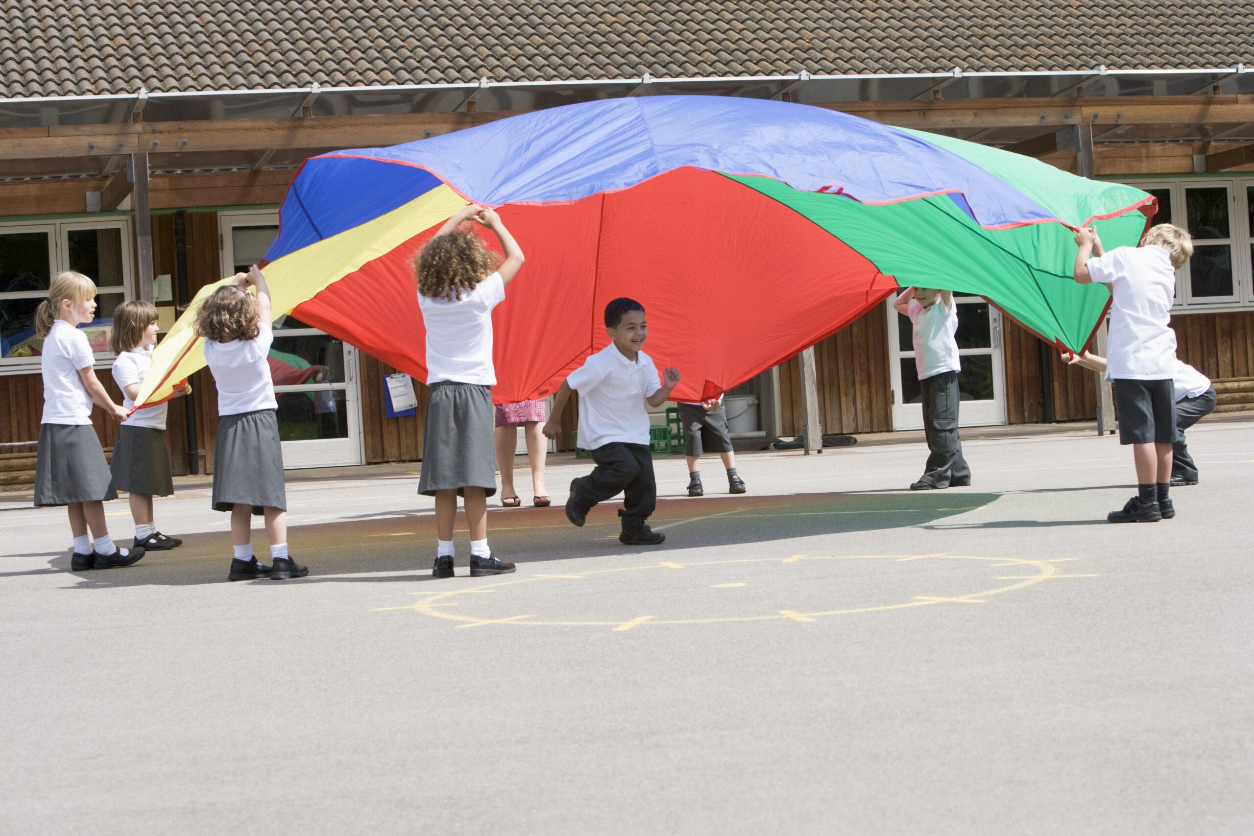 Young children playing a game with a parachute