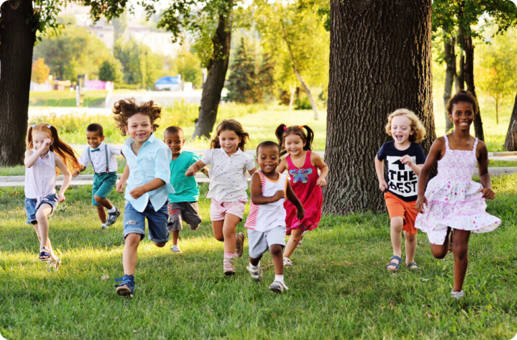 A group of children in a park running towards the camera